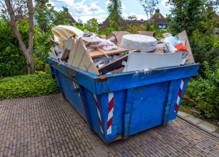 blue loaded garbage dumpster